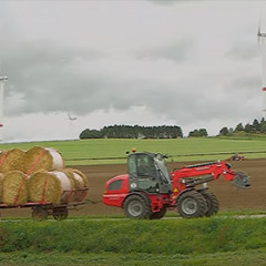 5080 T loading round bales and driving on the road with trailer